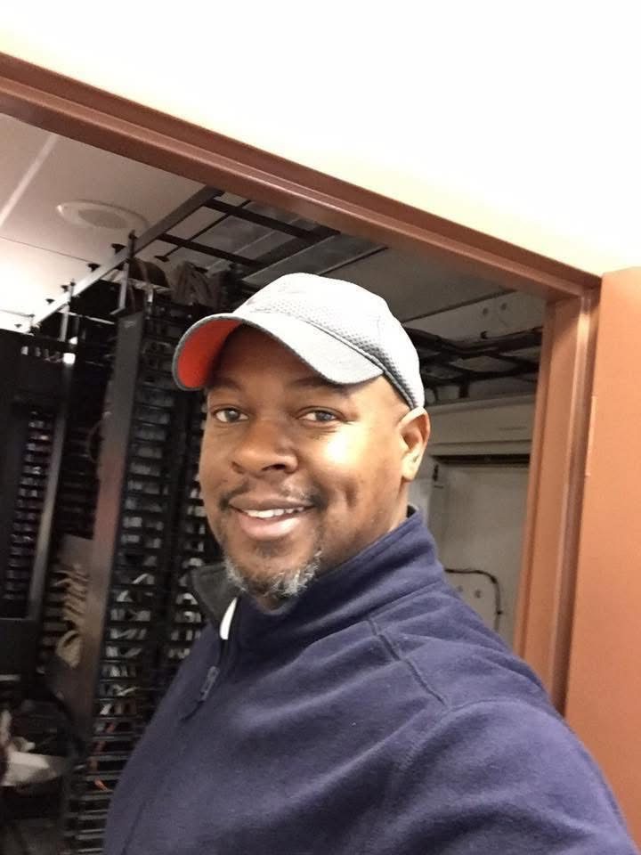 Amos Ross III at a network rack / MDF closet
