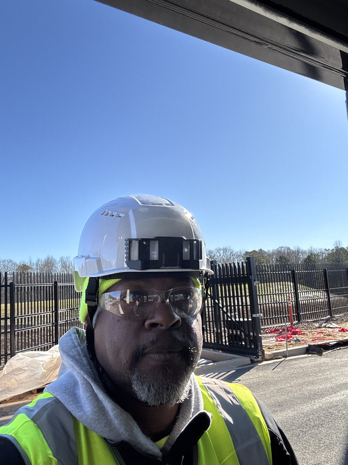Amos Ross III on a secured site in hard hat and hi-vis